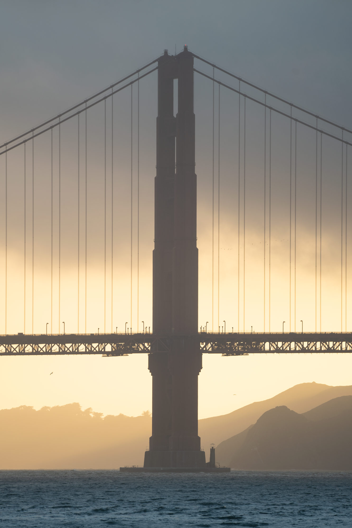 South tower of the Golden Gate Bridge during a foggy sunset